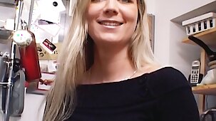 Outstanding German MILF with huge boobs dildoing her shaved muff in the kitchen